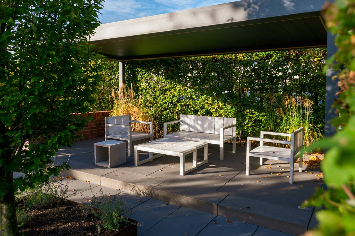 Modern pool furniture design ideas featuring aluminum loungers and synthetic wicker seating beside a clean-lined pool deck